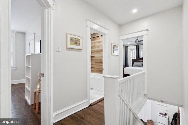 hallway with recessed lighting, baseboards, and dark wood-style flooring