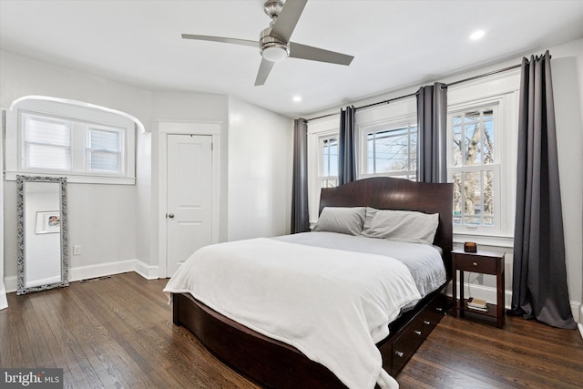 bedroom with a ceiling fan, recessed lighting, dark wood-style floors, and baseboards