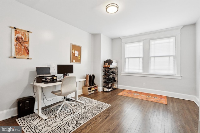 home office with baseboards and hardwood / wood-style flooring