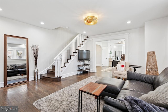 living room featuring recessed lighting, stairway, baseboards, and wood finished floors