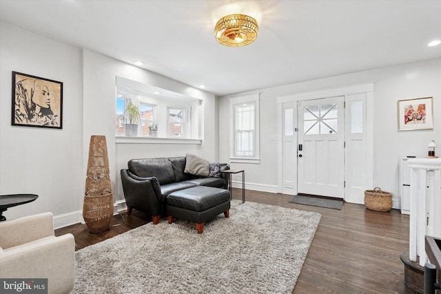 foyer featuring dark wood finished floors, recessed lighting, and baseboards