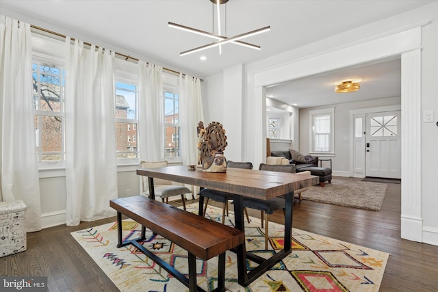 dining room featuring a notable chandelier, recessed lighting, baseboards, and wood finished floors