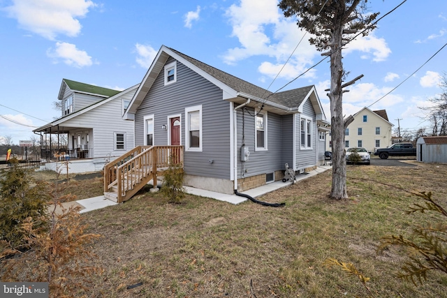 view of front of property with a shingled roof, a front yard, and fence