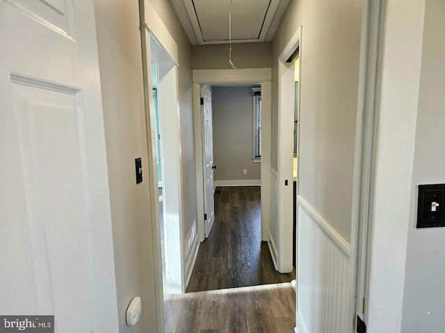 hall featuring attic access and wood finished floors