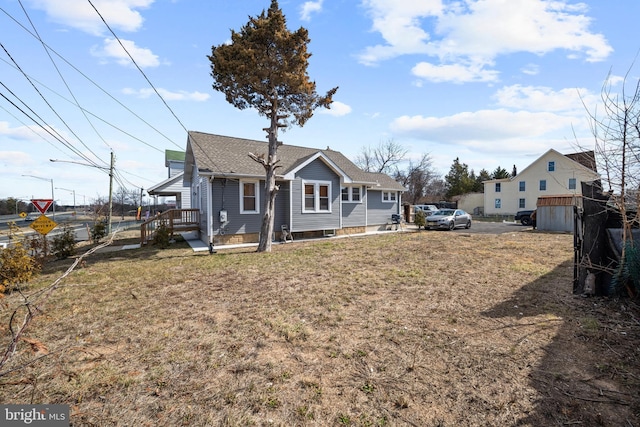 back of house with roof with shingles