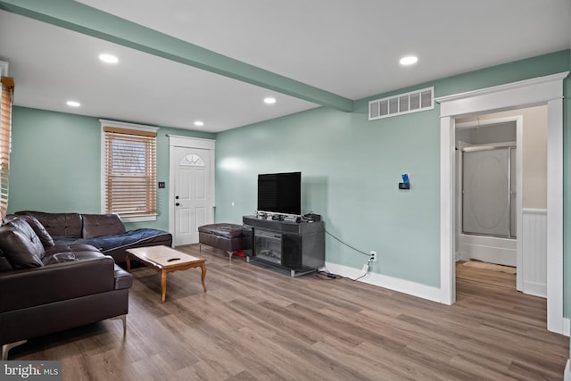 living area with recessed lighting, wood finished floors, visible vents, and baseboards