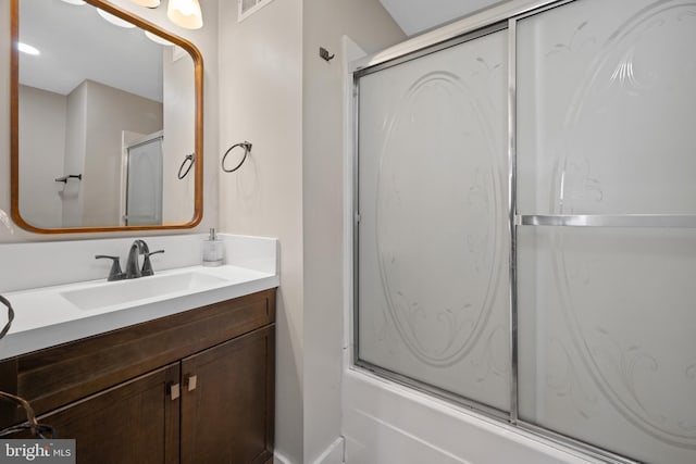 bathroom with enclosed tub / shower combo and vanity