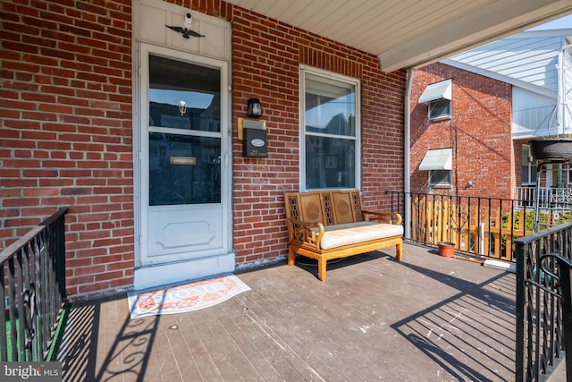 view of exterior entry featuring brick siding