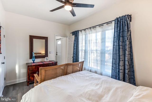 bedroom featuring baseboards, dark wood-type flooring, and ceiling fan