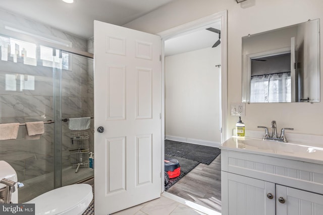 full bath with vanity, marble finish floor, a shower stall, and toilet