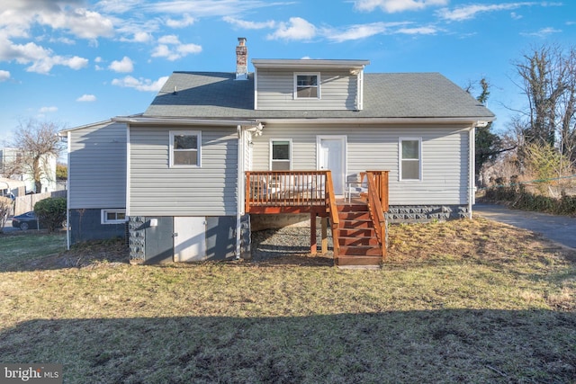 rear view of property with stairs, a yard, a wooden deck, and a chimney