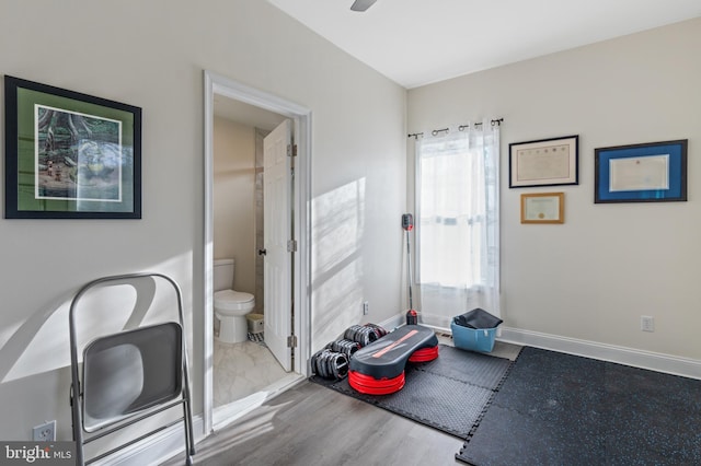 interior space with baseboards and wood finished floors