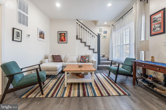 living room with stairway, recessed lighting, visible vents, and wood finished floors