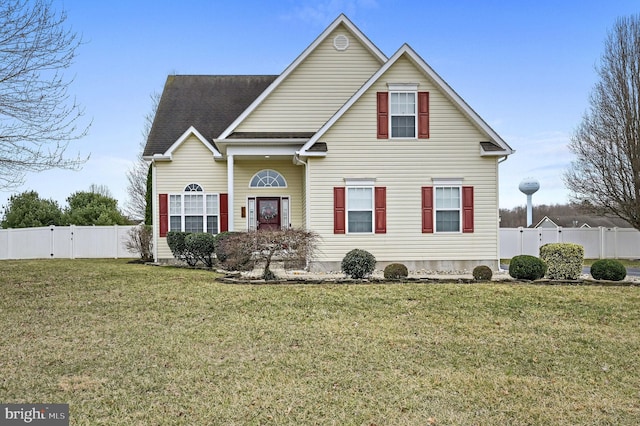 traditional home featuring a front yard and fence