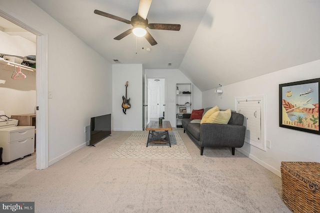 living area with a ceiling fan, baseboards, visible vents, lofted ceiling, and light colored carpet