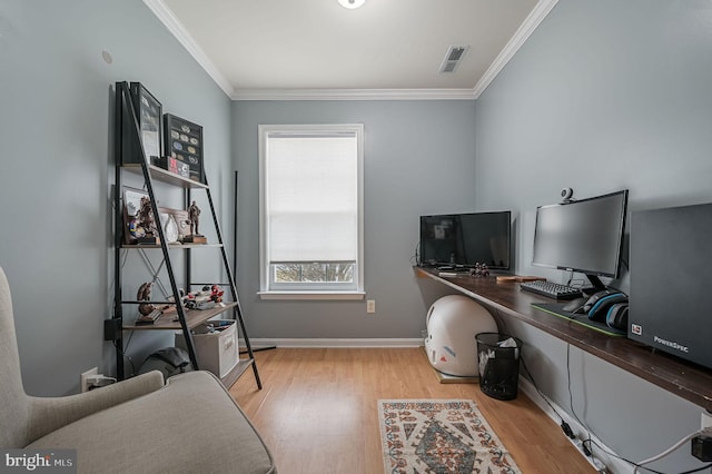 office space featuring visible vents, crown molding, baseboards, and wood finished floors