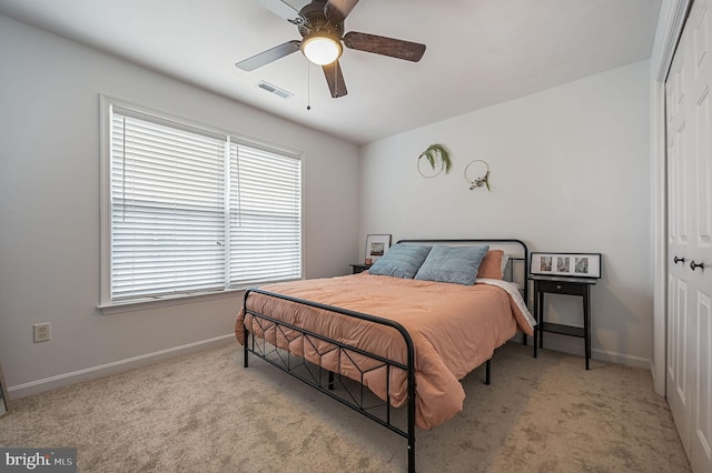 bedroom with a closet, visible vents, baseboards, and carpet floors