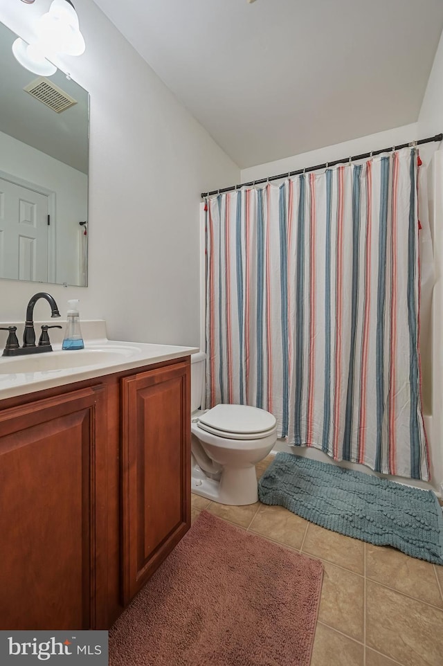 bathroom with visible vents, toilet, a shower with shower curtain, tile patterned flooring, and vanity