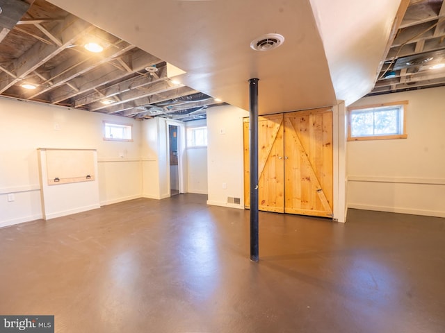 basement featuring visible vents and baseboards