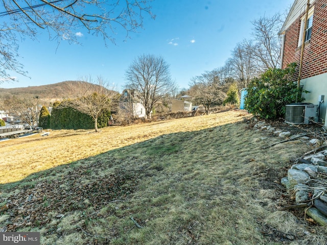 view of yard featuring central air condition unit and a mountain view