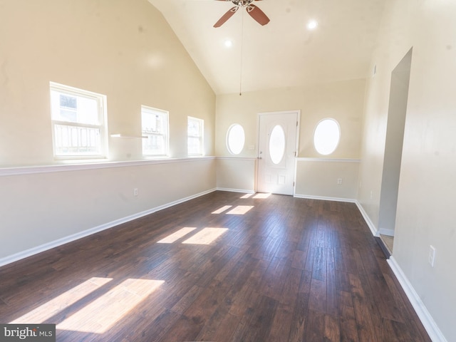 interior space featuring high vaulted ceiling, a ceiling fan, baseboards, and hardwood / wood-style floors