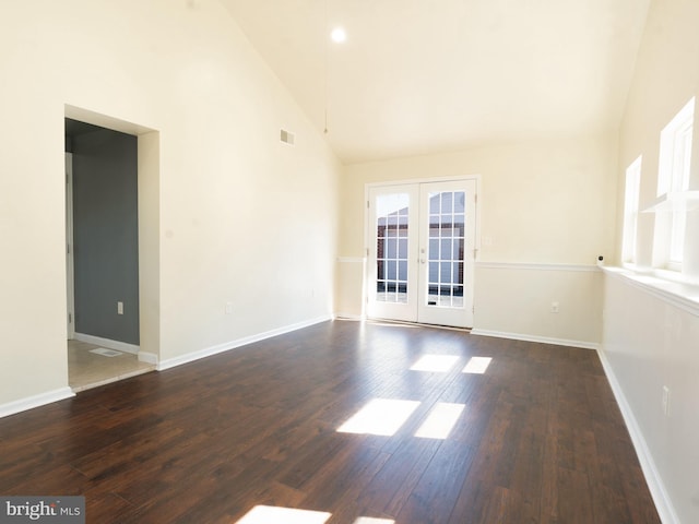 unfurnished room with wood finished floors, french doors, visible vents, and baseboards