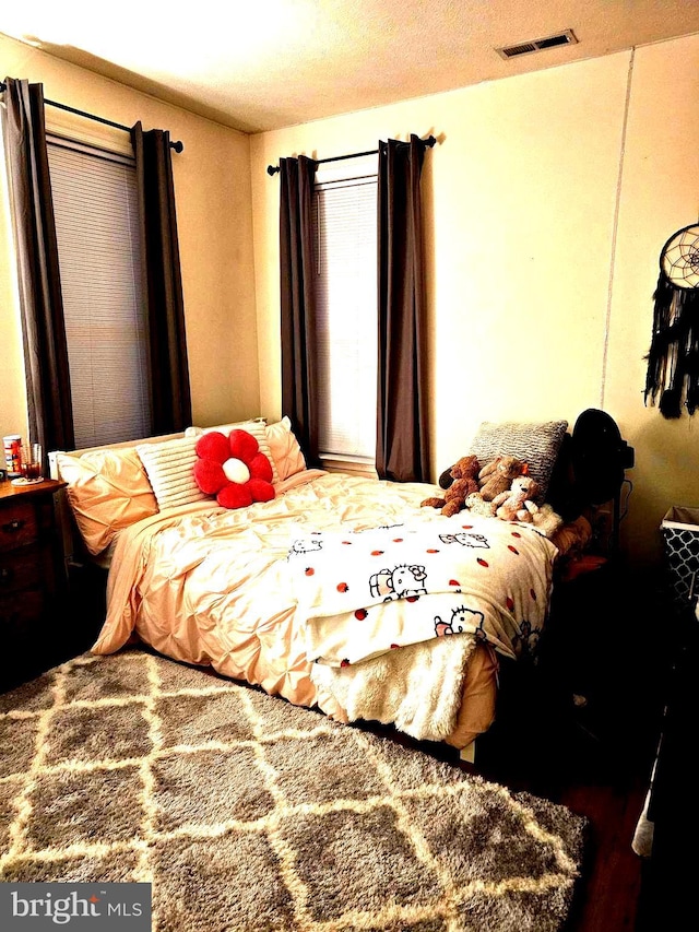 bedroom featuring visible vents and a textured ceiling