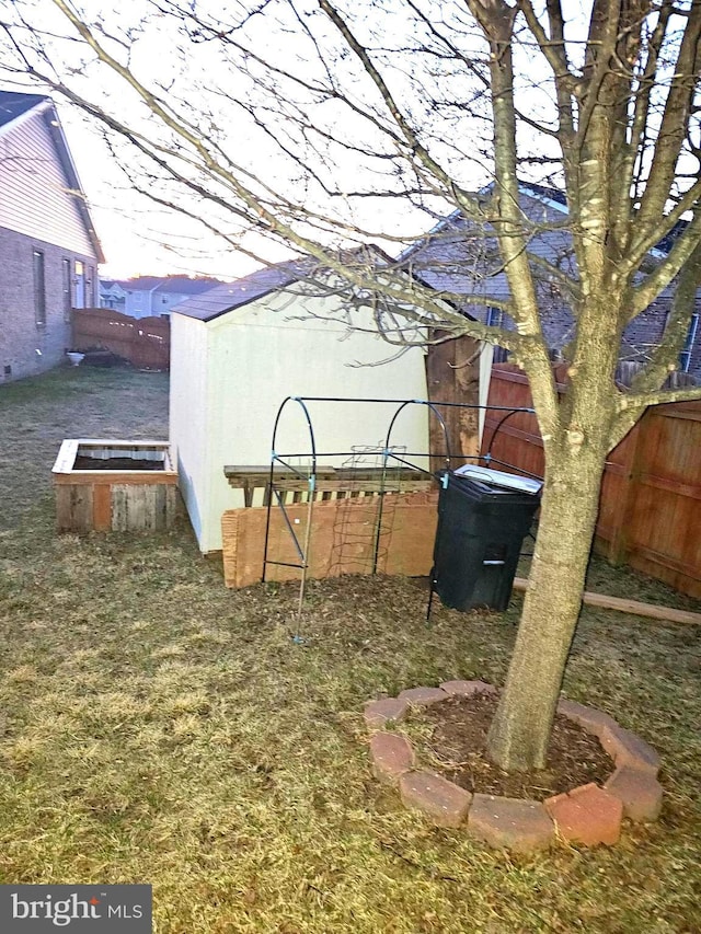 view of yard featuring an outdoor structure and fence