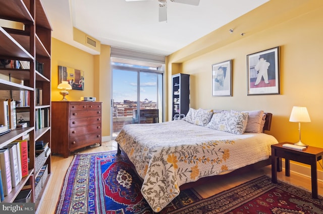 1400 Lancaster St Unit 605, Baltimore, MD 21231 - bedroom with visible vents, ceiling fan, baseboards, and wood finished floors