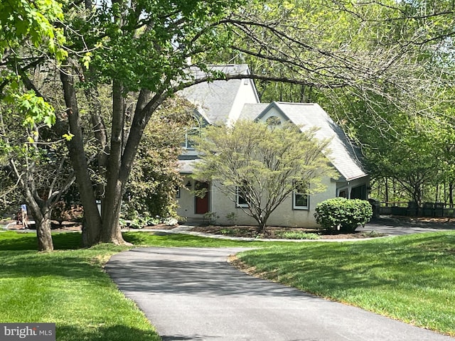 1052 Cedar Mill Ln, West Chester, PA 19382 - view of property hidden behind natural elements featuring stucco siding, a front lawn, and asphalt driveway