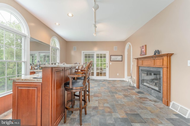 1052 Cedar Mill Ln, West Chester, PA 19382 - indoor dry bar featuring stone finish flooring, healthy amount of natural light, baseboards, and recessed lighting