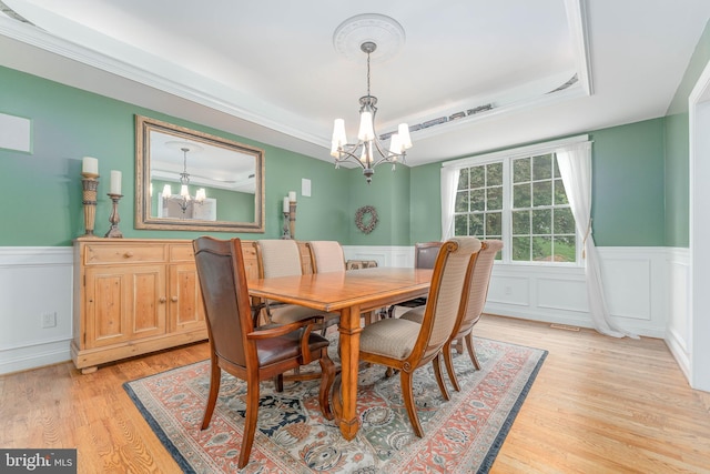 1052 Cedar Mill Ln, West Chester, PA 19382 - dining room with a chandelier, wainscoting, light wood finished floors, a raised ceiling, and a decorative wall