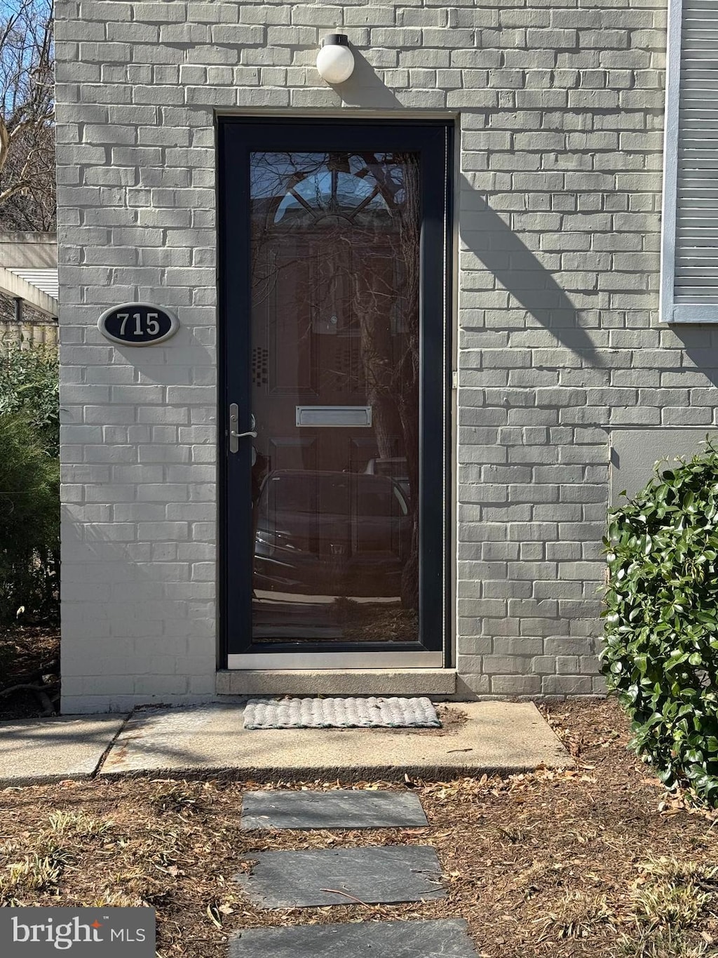 entrance to property featuring brick siding