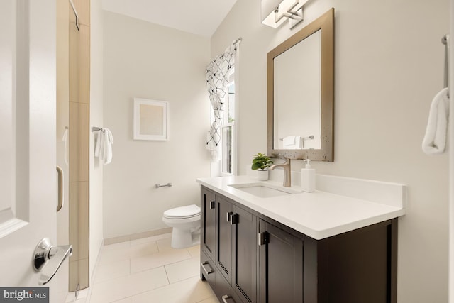 full bath with tile patterned flooring, toilet, vanity, and baseboards