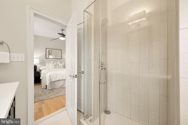 full bath featuring a ceiling fan, ensuite bath, and a shower stall