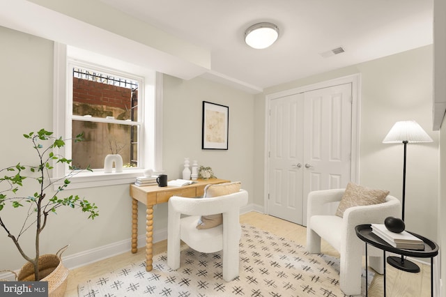 home office with baseboards, light wood-style floors, and visible vents
