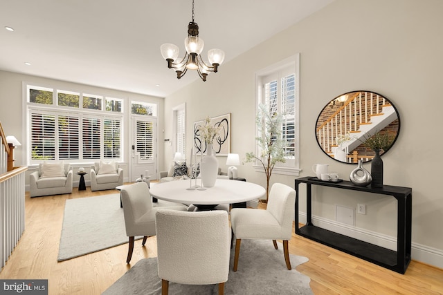 dining room with light wood finished floors, baseboards, recessed lighting, and a chandelier