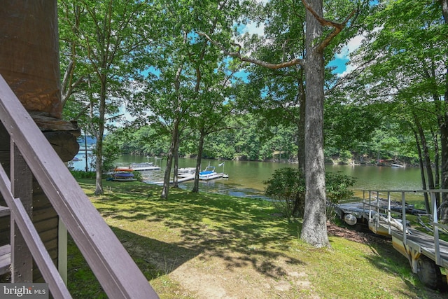 view of yard with a dock and a water view