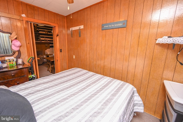 bedroom featuring a closet and wood walls