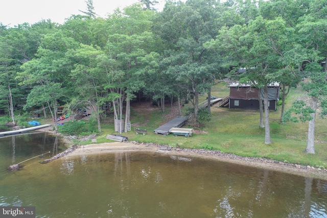 view of dock featuring a water view and a lawn