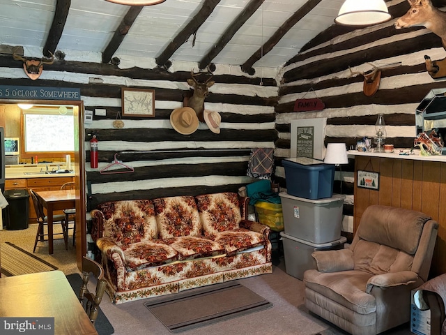 living area with lofted ceiling with beams, carpet flooring, and wooden ceiling