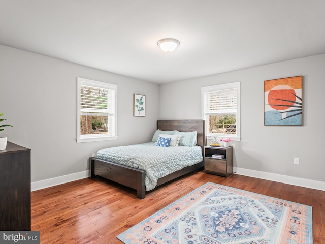 bedroom with wood finished floors and baseboards