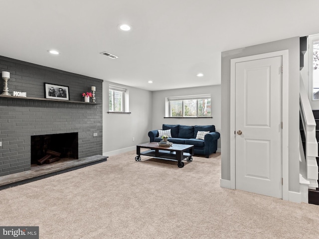 living room featuring carpet flooring, a fireplace, recessed lighting, and baseboards