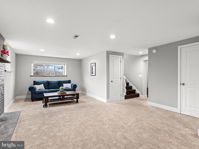 carpeted living area featuring recessed lighting, visible vents, baseboards, and stairs