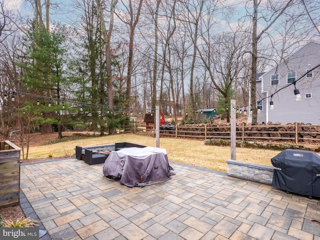 view of patio / terrace featuring fence and a grill