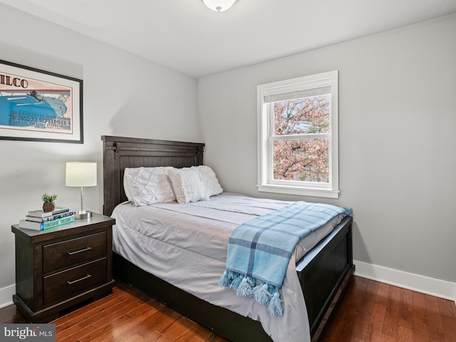 bedroom featuring dark wood-type flooring and baseboards