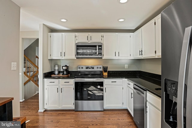 kitchen featuring white cabinetry, light wood-style flooring, recessed lighting, and stainless steel appliances