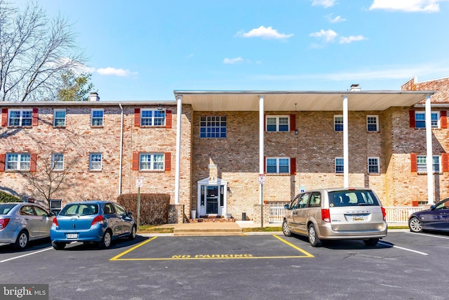 view of property with uncovered parking