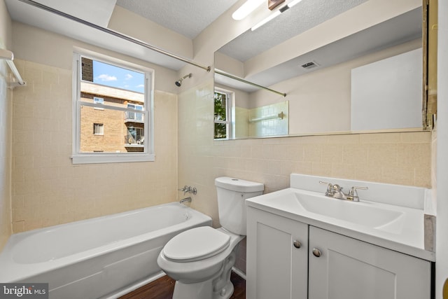 bathroom featuring visible vents, tile walls,  shower combination, and a healthy amount of sunlight