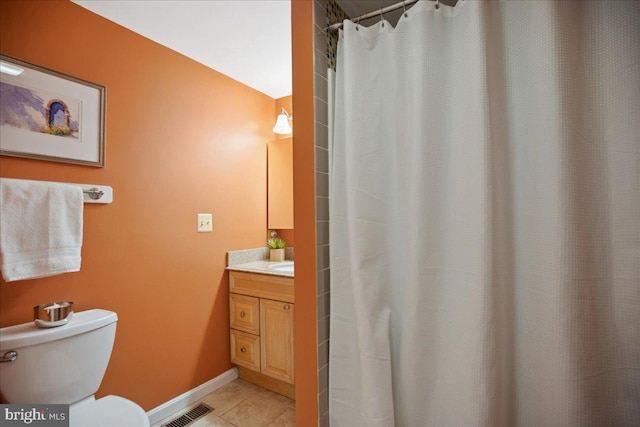 full bathroom with vanity, baseboards, visible vents, tile patterned floors, and toilet